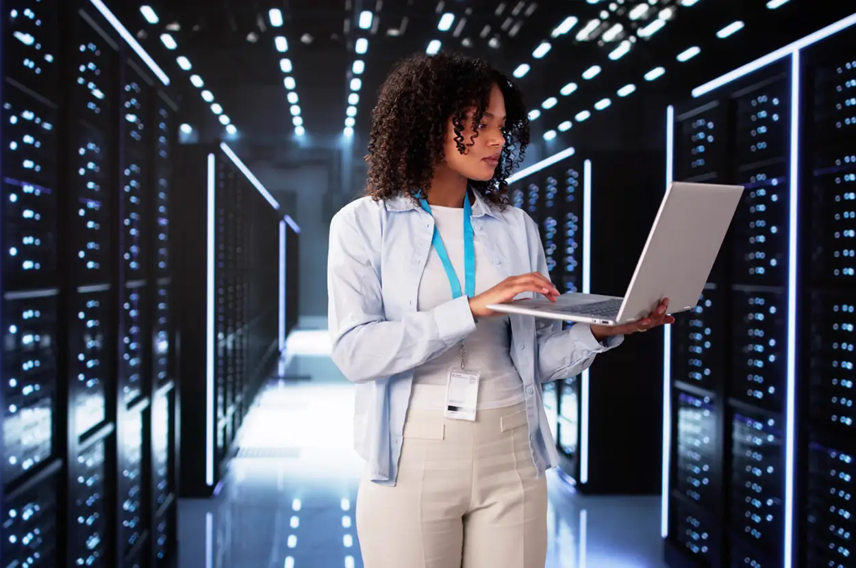 Woman with a laptop in a data center.