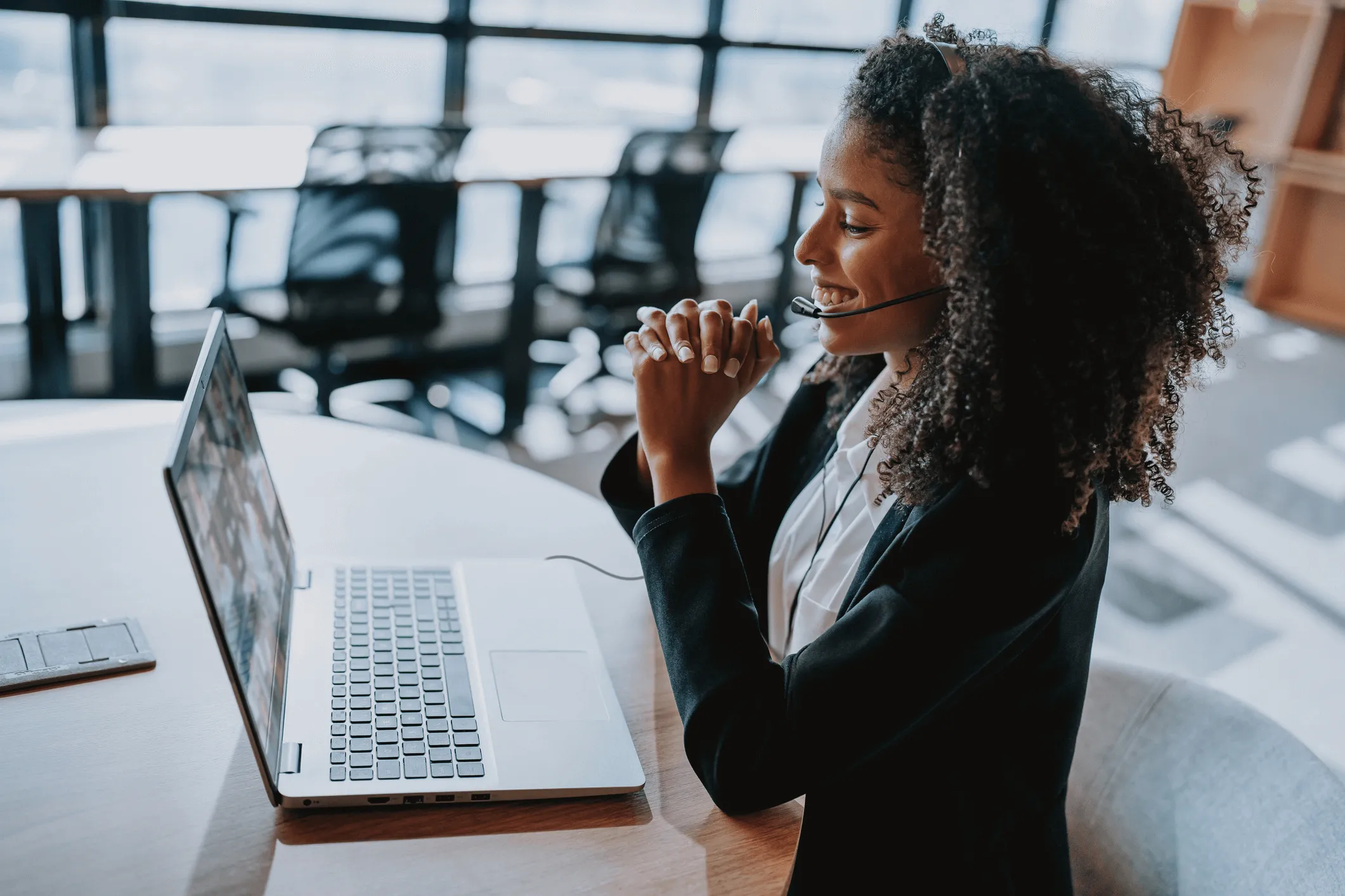 SADOS help desk technician providing remote IT support via headset and laptop.