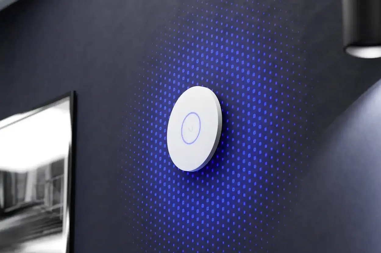 Modern wall-mounted device with blue LED lights on a dotted background, ideal for smart home automation.