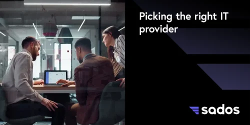 Three professionals discuss choosing the right IT provider at a modern office meeting.